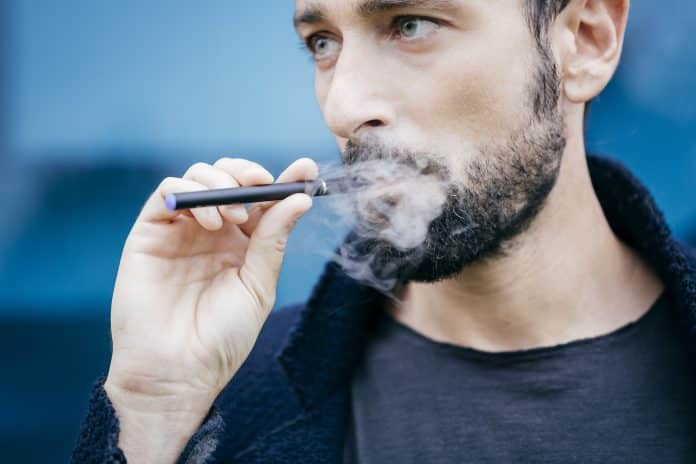 Portrait of man smoking an electronic cigarette