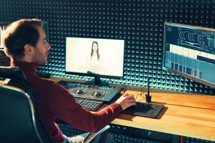 Male Videographer Edits and Cuts Footage and Sound on His Personal Computer montage video workflow
