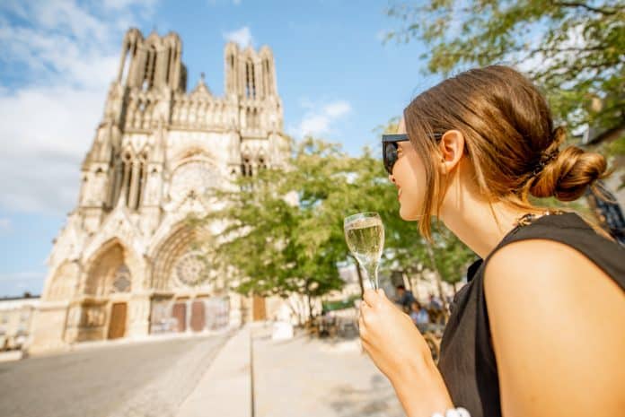 Woman with a glass of champagne in Reims, France Séjour à Reims